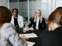 Women at a table having a conference.