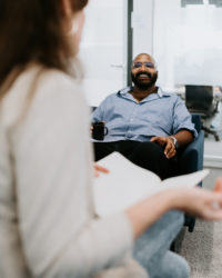 Man sitting on a couch and smiling.