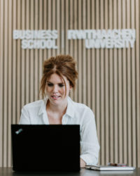 Woman typing into laptop.