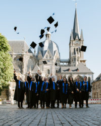 Group of graduates throwing their hats.
