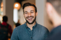 man at a restaurant laughing - happy