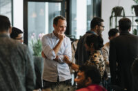 professor unterhaelt sich mit studierenden bei dinner