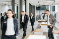 people in suits in an office building - technology