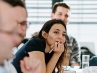 Women in a class room is listening to the lecture