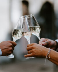 three people toast with sparkling wine